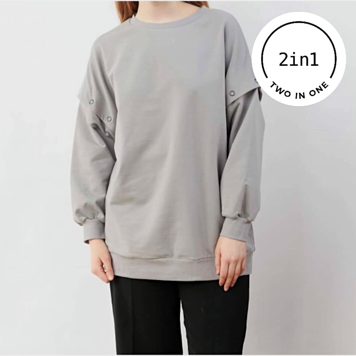 Graues Sweatshirt mit abnehmbaren Ärmeln an Frauenkörper mit weißem, rundem 2IN1-Icon