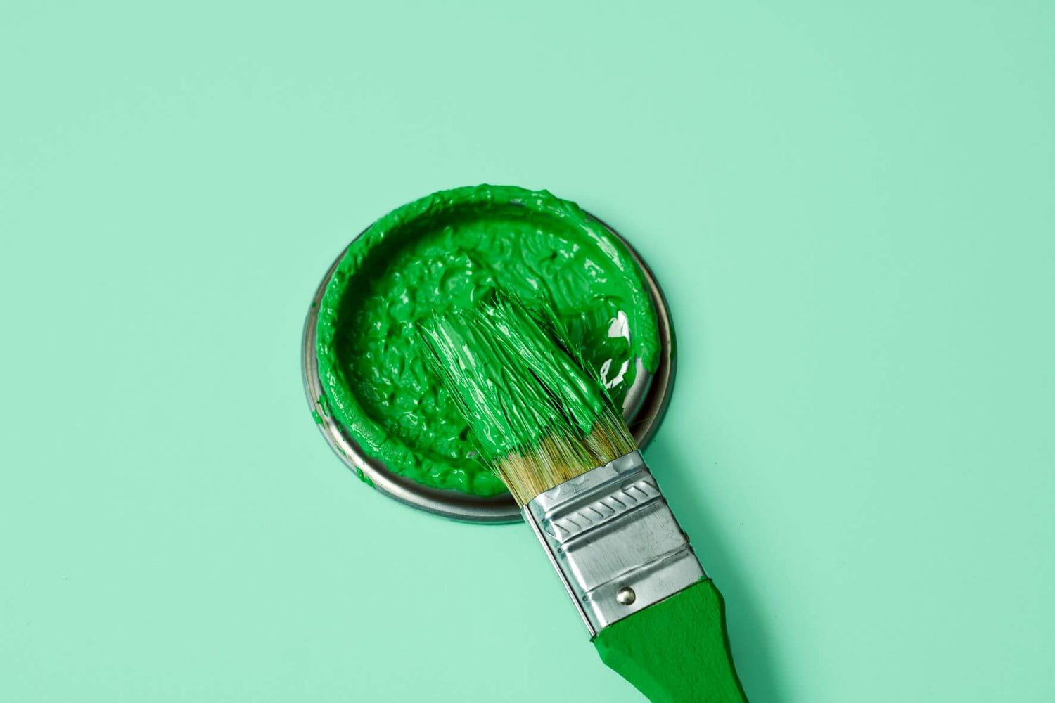 Verblidlichung von Greenwashing in Form von grünem Pinsel auf hellgrünem Grund
